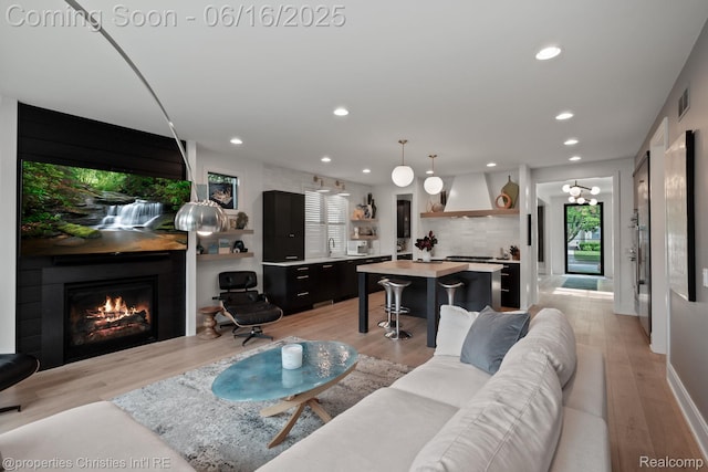 1044 Hazel, Birmingham, MI 48009 - living area with recessed lighting, light wood-style flooring, and a fireplace