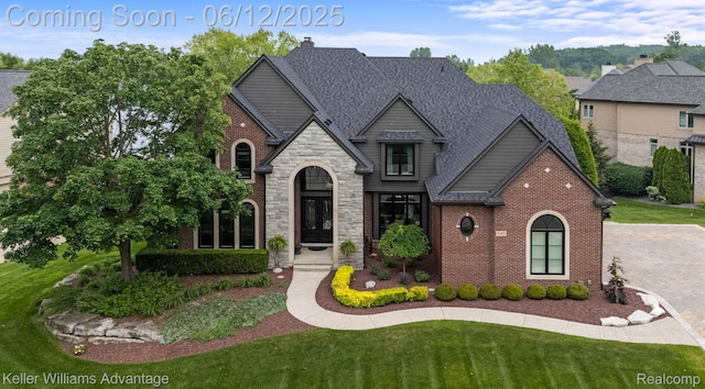 10993 Stoney Point Dr, South Lyon, MI 48178 - view of front facade featuring brick siding, a front lawn, and stone siding