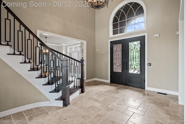 10993 Stoney Point Dr, South Lyon, MI 48178 - entrance foyer with a towering ceiling, baseboards, stone tile flooring, and stairs