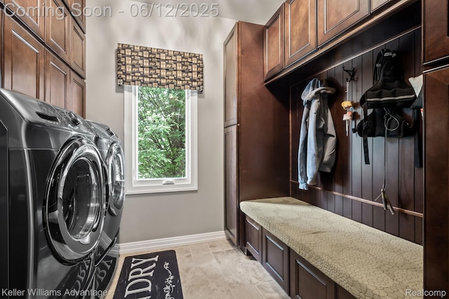 10993 Stoney Point Dr, South Lyon, MI 48178 - laundry area featuring cabinet space, washing machine and dryer, and baseboards