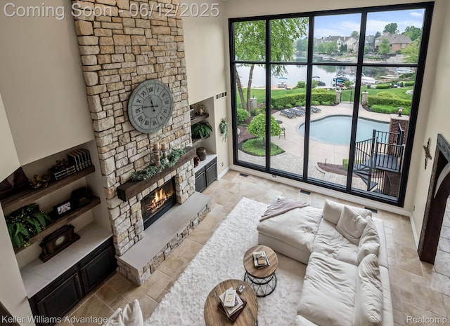 10993 Stoney Point Dr, South Lyon, MI 48178 - living area featuring a fireplace and a water view