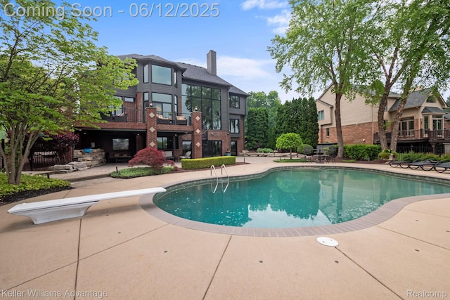 10993 Stoney Point Dr, South Lyon, MI 48178 - outdoor pool featuring a patio area and a diving board