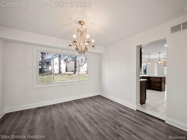 6150 Anne Dr, West Bloomfield, MI 48322 - unfurnished dining area featuring a chandelier and wood finished floors