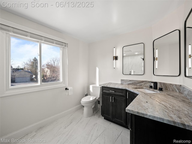 6150 Anne Dr, West Bloomfield, MI 48322 - bathroom with vanity, baseboards, marble look tiles, and toilet