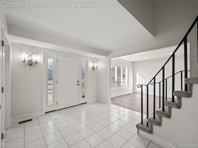 6150 Anne Dr, West Bloomfield, MI 48322 - foyer with light tile patterned floors, stairs, and recessed lighting