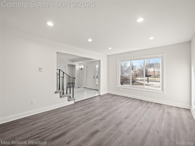6150 Anne Dr, West Bloomfield, MI 48322 - unfurnished living room with recessed lighting, stairs, wood finished floors, and baseboards