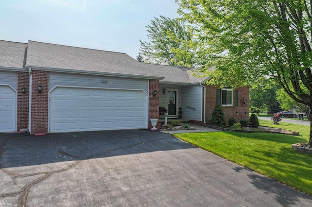 1273 Crystal Pointe Cir, Fenton, MI 48430 - view of front of house with brick siding, driveway, a garage, and a front yard