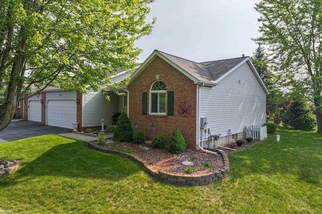 1273 Crystal Pointe Cir, Fenton, MI 48430 - view of front facade featuring brick siding, asphalt driveway, a front lawn, a shingled roof, and a garage