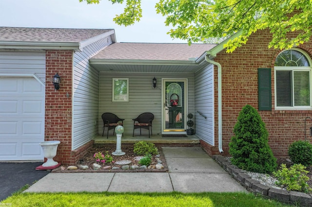1273 Crystal Pointe Cir, Fenton, MI 48430 - view of exterior entry with a garage, covered porch, brick siding, and roof with shingles