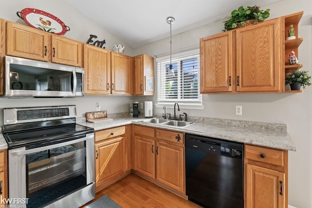 1273 Crystal Pointe Cir, Fenton, MI 48430 - kitchen featuring appliances with stainless steel finishes, light wood-style floors, open shelves, and hanging light fixtures