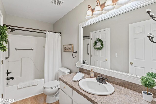 1273 Crystal Pointe Cir, Fenton, MI 48430 - bathroom with vanity, shower / bath combination with curtain, and wood finished floors