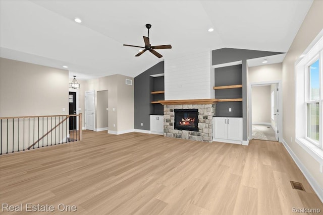 2763 Clivedon Rd, Howell, MI 48843 - unfurnished living room featuring vaulted ceiling, a ceiling fan, built in features, light wood-style flooring, and baseboards