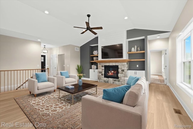 2763 Clivedon Rd, Howell, MI 48843 - living room featuring a ceiling fan, light wood-style flooring, vaulted ceiling, built in features, and recessed lighting