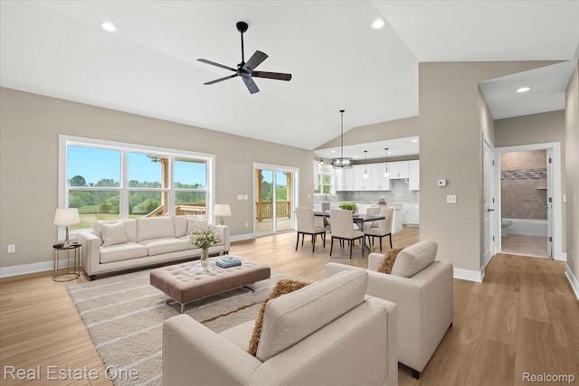 2763 Clivedon Rd, Howell, MI 48843 - living area featuring baseboards, a ceiling fan, light wood-style floors, high vaulted ceiling, and recessed lighting