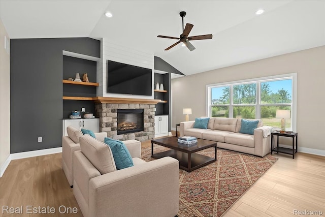 2763 Clivedon Rd, Howell, MI 48843 - living room featuring vaulted ceiling, baseboards, ceiling fan, wood finished floors, and built in shelves