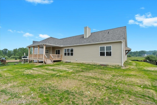 2763 Clivedon Rd, Howell, MI 48843 - back of property featuring a lawn, a chimney, and a wooden deck