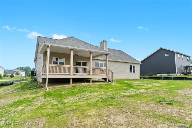 2763 Clivedon Rd, Howell, MI 48843 - back of property with a ceiling fan, a chimney, a wooden deck, and central AC unit