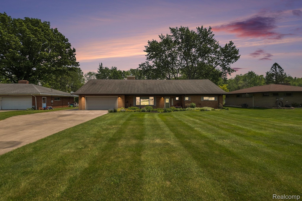 3108 Gehring Dr, Flint, MI 48506 - ranch-style house with a garage, concrete driveway, a yard, and a chimney