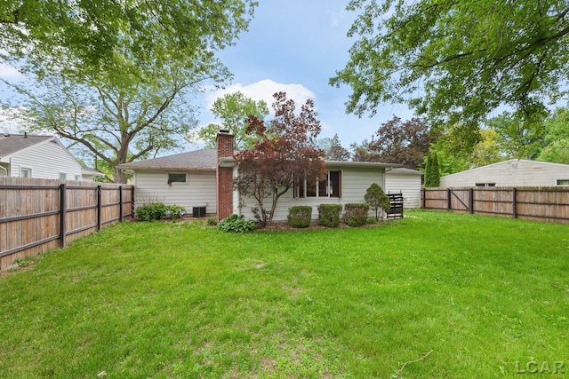 345 Alexander Dr, Adrian, MI 49221 - back of house featuring a chimney and central AC unit