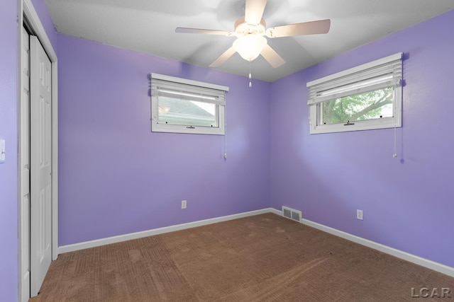 345 Alexander Dr, Adrian, MI 49221 - unfurnished bedroom featuring multiple windows, a closet, carpet, and baseboards