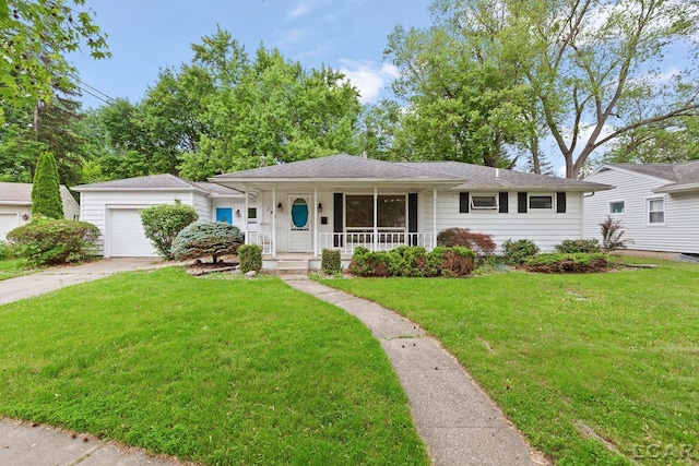345 Alexander Dr, Adrian, MI 49221 - single story home with a porch, concrete driveway, a garage, and a front lawn