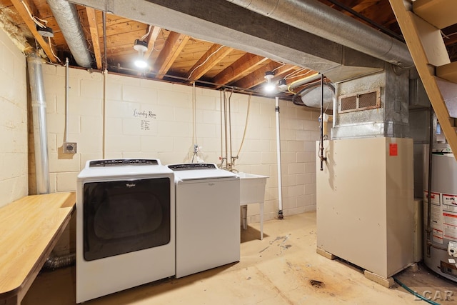 345 Alexander Dr, Adrian, MI 49221 - laundry room with gas water heater, washer and clothes dryer, and heating unit