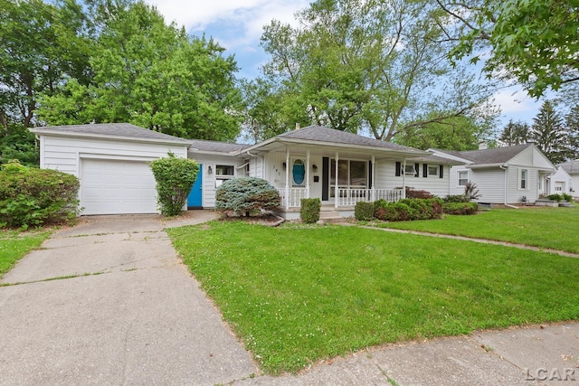 345 Alexander Dr, Adrian, MI 49221 - view of front facade with covered porch, a garage, driveway, and a front yard