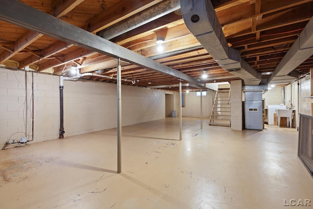 345 Alexander Dr, Adrian, MI 49221 - unfinished below grade area with stairway, heating unit, and concrete block wall