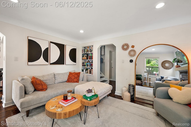 929 Columbia Rd, Berkley, MI 48072 - living room featuring dark wood-type flooring, arched walkways, recessed lighting, stairway, and built in shelves