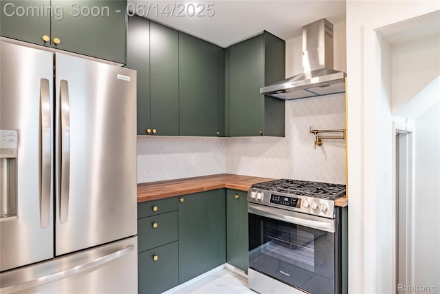 17330 Five Points St E, Dearborn, MI 48240 - kitchen with appliances with stainless steel finishes, wall chimney exhaust hood, butcher block counters, green cabinetry, and backsplash