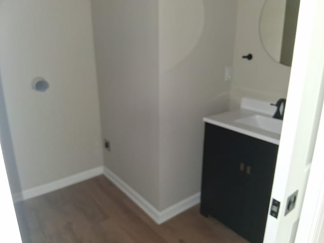243 Lake Dr, Muskegon, MI 49441 - bathroom featuring vanity and wood finished floors