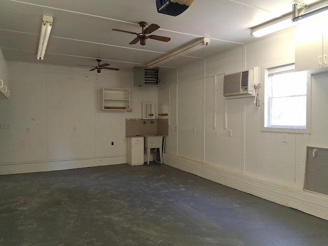 243 Lake Dr, Muskegon, MI 49441 - garage featuring a wall unit AC, a garage door opener, and a ceiling fan