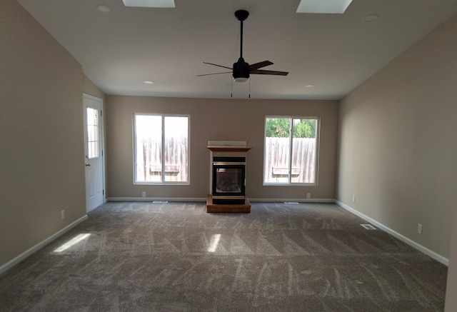 243 Lake Dr, Muskegon, MI 49441 - unfurnished living room featuring carpet, ceiling fan, a skylight, and recessed lighting