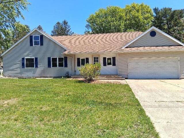 243 Lake Dr, Muskegon, MI 49441 - view of front of property with an attached garage, a front yard, concrete driveway, a porch, and roof with shingles
