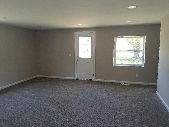 243 Lake Dr, Muskegon, MI 49441 - empty room with dark carpet and recessed lighting