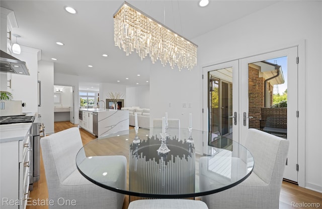 3856 Pine Lake Knoll Dr, West Bloomfield, MI 48324 - dining area with french doors, light wood finished floors, recessed lighting, and a chandelier