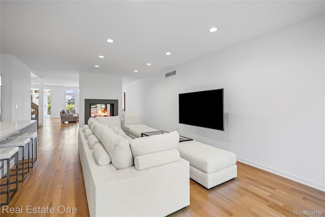 3856 Pine Lake Knoll Dr, West Bloomfield, MI 48324 - living area featuring light wood-type flooring, recessed lighting, a multi sided fireplace, and baseboards