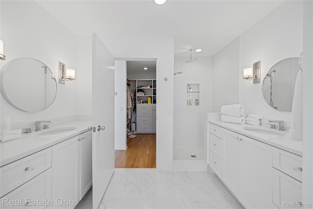 3856 Pine Lake Knoll Dr, West Bloomfield, MI 48324 - bathroom featuring tiled shower, two vanities, recessed lighting, and a spacious closet