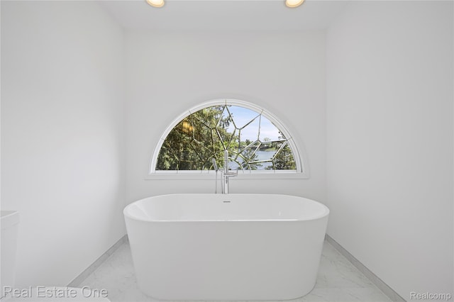 3856 Pine Lake Knoll Dr, West Bloomfield, MI 48324 - full bath featuring marble look tiles, a freestanding tub, baseboards, and recessed lighting