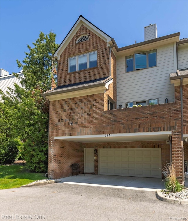 3856 Pine Lake Knoll Dr, West Bloomfield, MI 48324 - view of front of home featuring a chimney, brick siding, an attached garage, and asphalt driveway