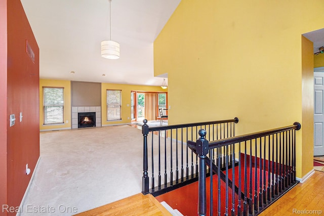 1130 Andover Cir, Commerce Twp, MI 48390 - staircase with baseboards, a fireplace, and carpet