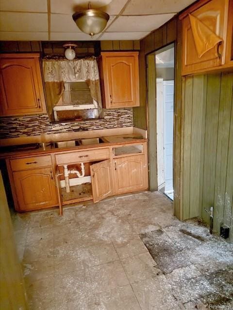 19537 Hamburg St, Detroit, MI 48205 - kitchen featuring tasteful backsplash, wooden walls, and brown cabinets