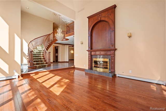 5148 Crest Knls, Bloomfield Hills, MI 48302 - unfurnished living room with a high ceiling, wood finished floors, a chandelier, stairway, and a baseboard heating unit