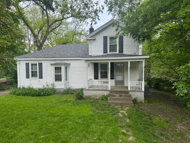 1673 Broadway St, Ann Arbor, MI 48105 - view of front of house with covered porch, a front yard, a chimney, and roof with shingles