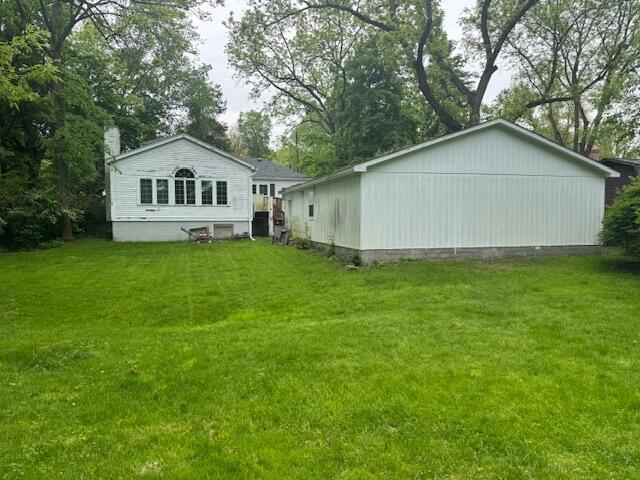 1673 Broadway St, Ann Arbor, MI 48105 - rear view of property featuring a lawn