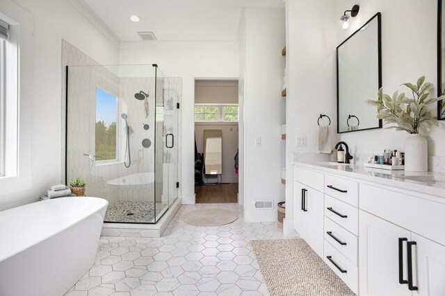 2958 S Edgar Rd, Mason, MI 48854 - bathroom with vanity, a soaking tub, a stall shower, tile patterned flooring, and recessed lighting
