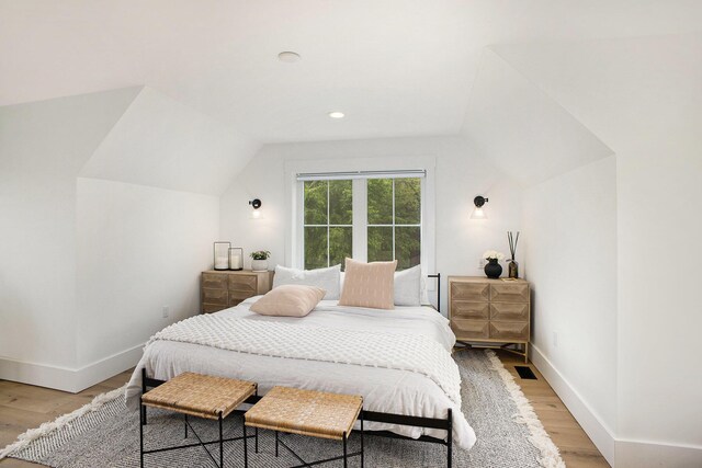 2958 S Edgar Rd, Mason, MI 48854 - bedroom with vaulted ceiling, light wood-style flooring, baseboards, and recessed lighting