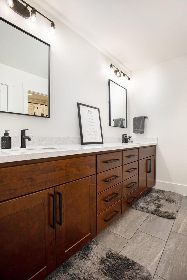 2958 S Edgar Rd, Mason, MI 48854 - bathroom with double vanity and baseboards