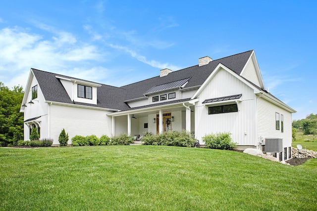 2958 S Edgar Rd, Mason, MI 48854 - modern inspired farmhouse featuring a standing seam roof, a front yard, metal roof, and a chimney