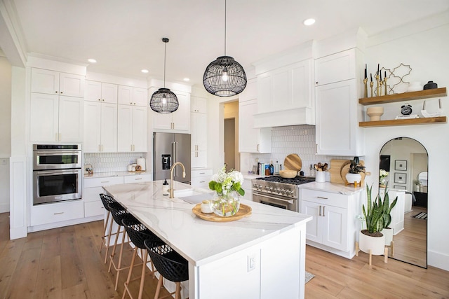 2958 S Edgar Rd, Mason, MI 48854 - kitchen featuring high quality appliances, a breakfast bar, light wood-style floors, tasteful backsplash, and recessed lighting